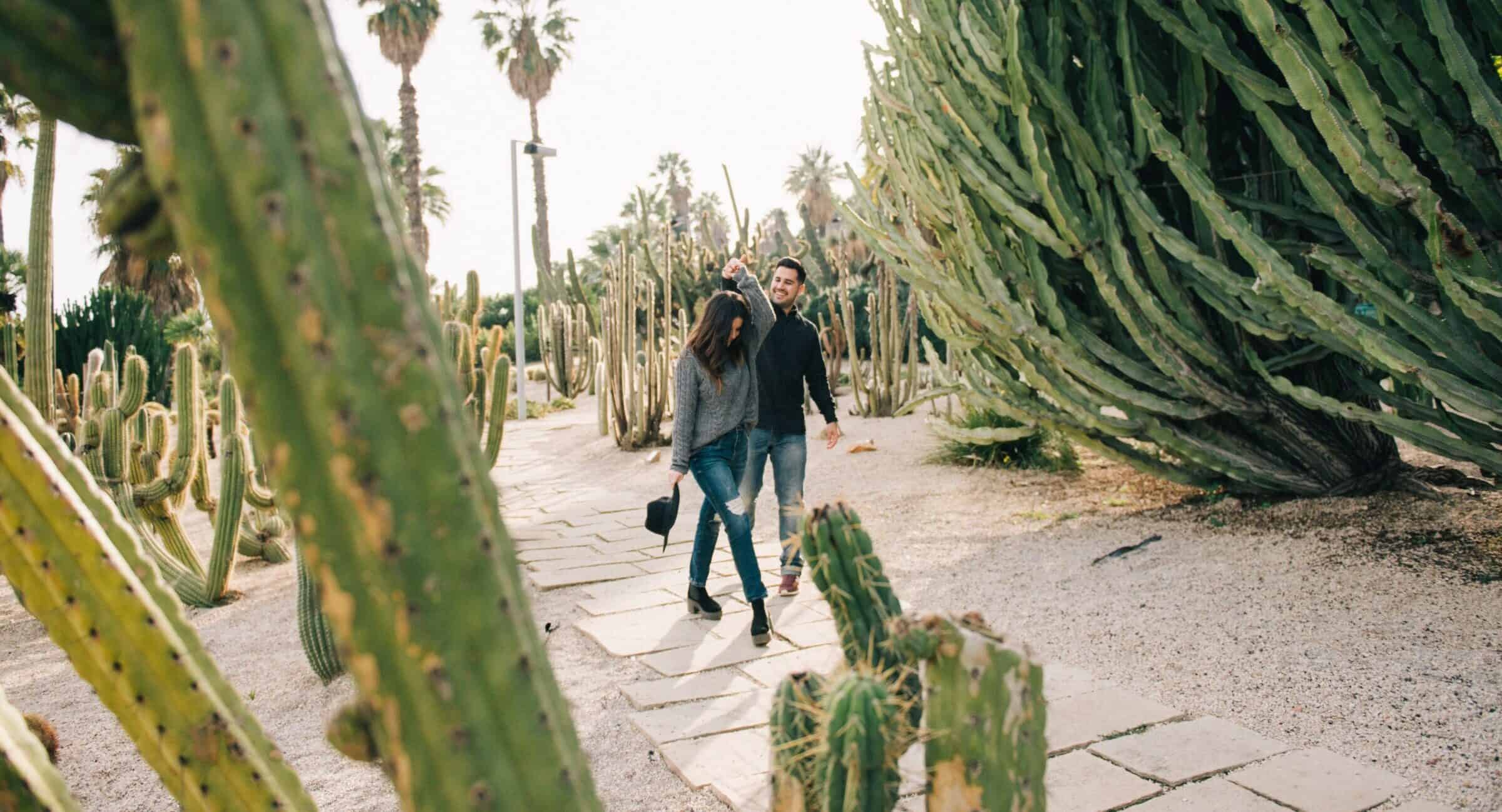 Couple walking down path with cactuses in San Diego