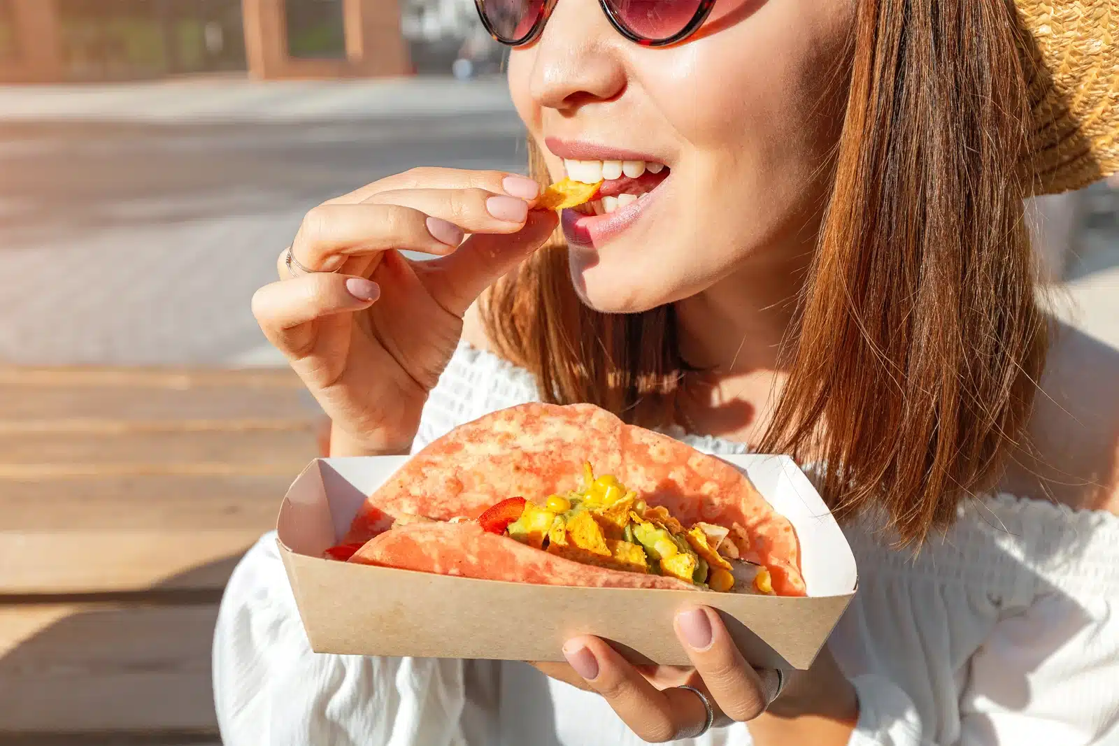 Woman eating taco